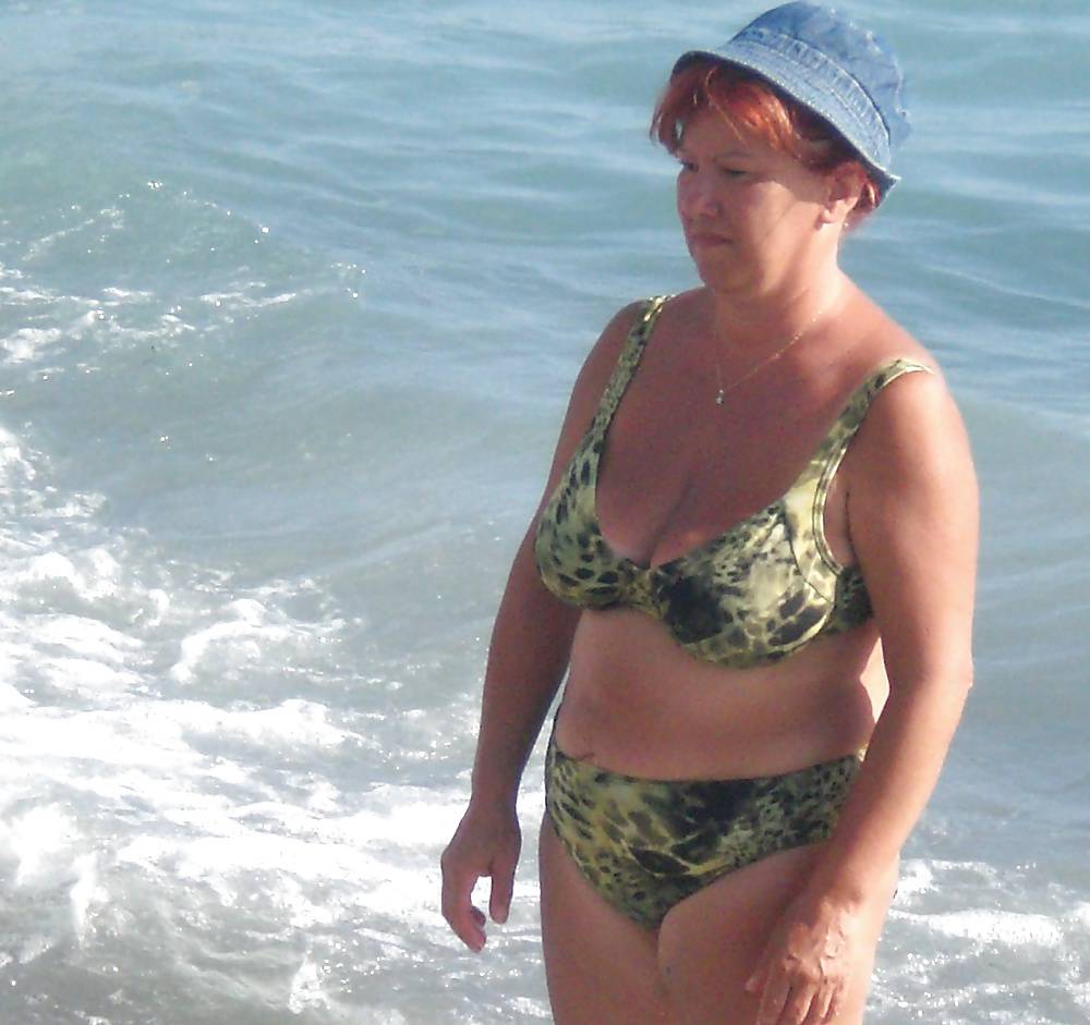 Old ladies with big tits in a swimsuit on the beach